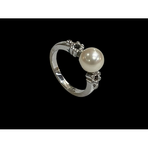 209 - Mikimoto pearl and fourteen stone diamond, 18 carat white gold ring, size M.