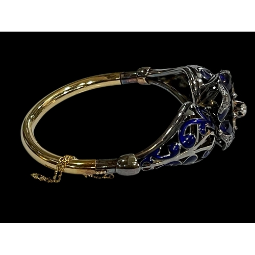 215 - Impressive 18 carat gold, diamond and blue enamel bangle, having elevated 0.25 carat diamond at the ... 