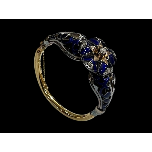 215 - Impressive 18 carat gold, diamond and blue enamel bangle, having elevated 0.25 carat diamond at the ... 