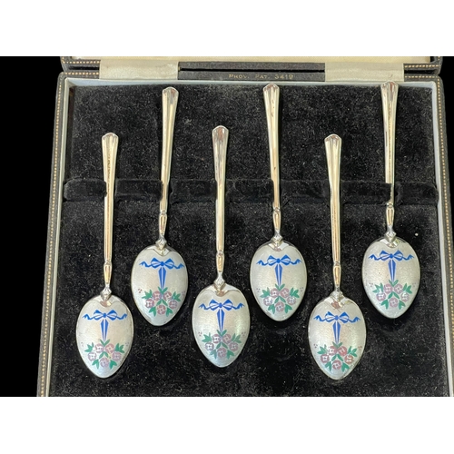 252 - Boxed set of six silver and enamel coffee spoons.