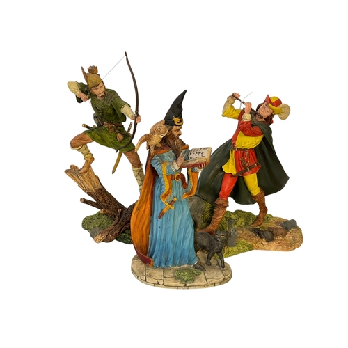 268 - Three Royal Doulton figures including Peter Pan, Pied Piper and Wizard.