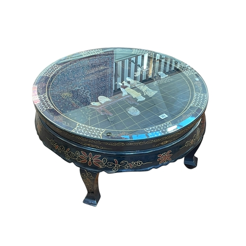 361 - Oriental black lacquered circular coffee table with applied figure decoration, 39cm by 76cm diameter... 