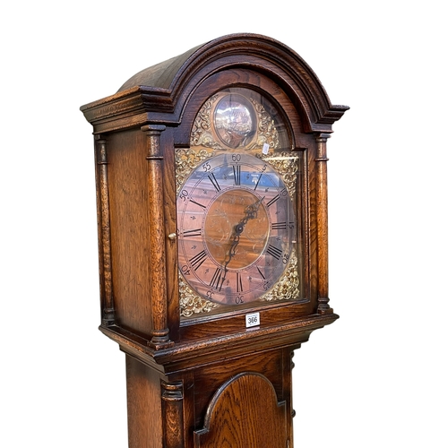 366 - Reproduction oak triple weight longcase clock having arched brass and silvered dial, MD Laverton, Yo... 