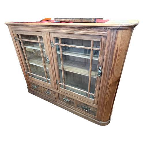 376 - Victorian pitch pine bookcase having two glazed panel doors enclosing four adjustable shelves with f... 