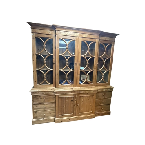 385 - Continental pine breakfront cabinet bookcase having four glazed panel doors above two central cupboa... 