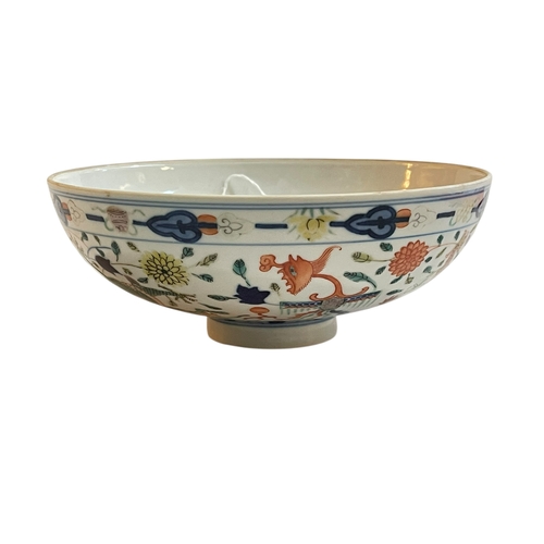 104 - Chinese circular footed bowl decorated with dragons, six character mark to base, 18.5cm.