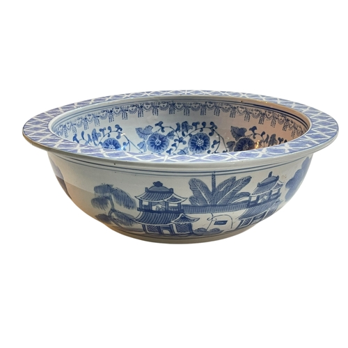 122 - Large Chinese blue and white pottery bowl with outer landscape and inner floral design, 36.5cm.