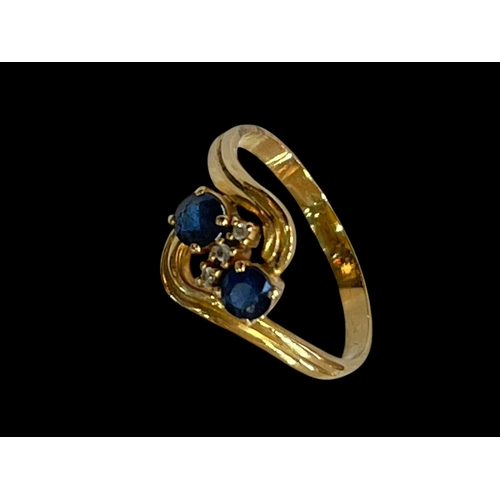 166 - Sapphire and diamond twist design ring set in yellow unmarked gold (18ct ?), size V.