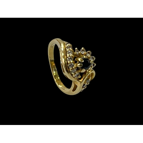 172 - Sapphire and diamond ring set in 18 carat yellow gold, size J.