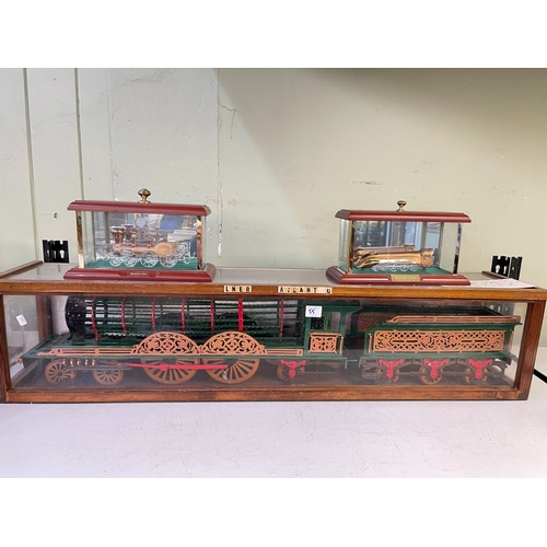 55 - Collection of model trains in display cases.