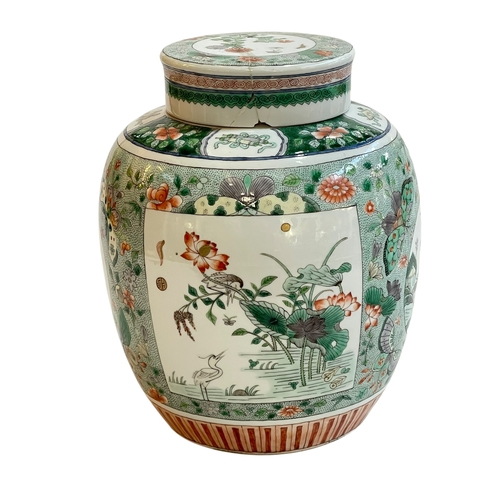 113 - Chinese famille verté jar and cover decorated with panels on floral ground, Qing Dynasty, 24cm.