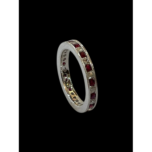 143 - Diamond and ruby 9 carat white gold eternity ring, size N.