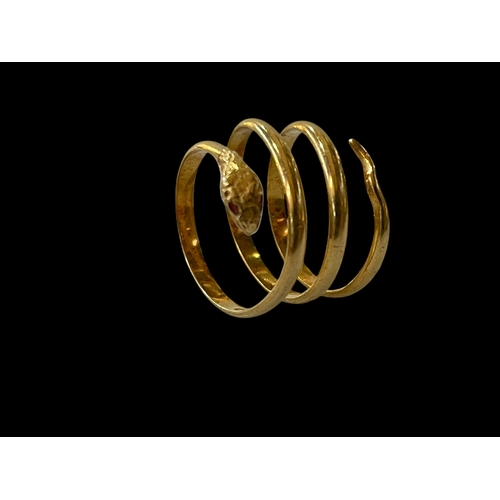 199 - 18 carat gold snake ring with ruby eyes, size S/T.