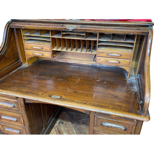 350 - Early 20th Century oak seven drawer roll top pedestal desk, 125cm by 127cm by 80cm.