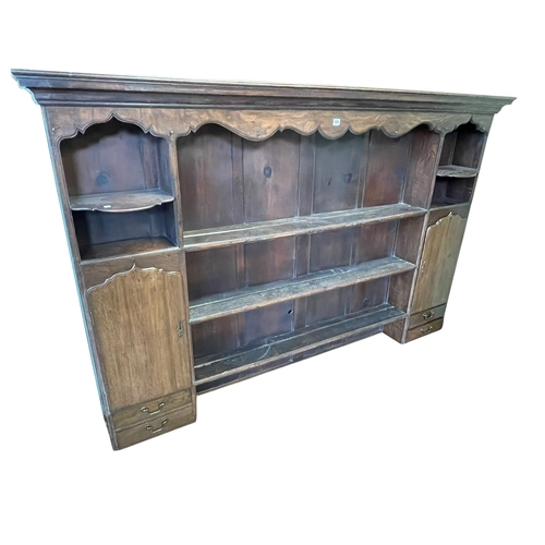 356 - Antique oak dresser top having three central shelves flanked by a shaped shelf above a cupboard door... 