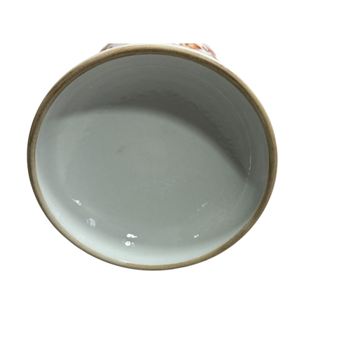 143 - Chinese iron red holy water vase, the baluster body on a domed base decorated with lotus sprays, 23c... 