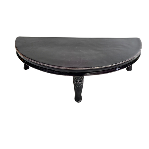 148 - Chinese porcelain demi lune stand raised on three face mask and paw feet, 26cm by 14cm.