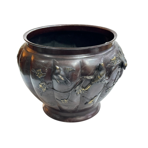 152 - Large Japanese bronze jardiniere decorated with raised bird and foliage, 28cm high by 40cm deep.