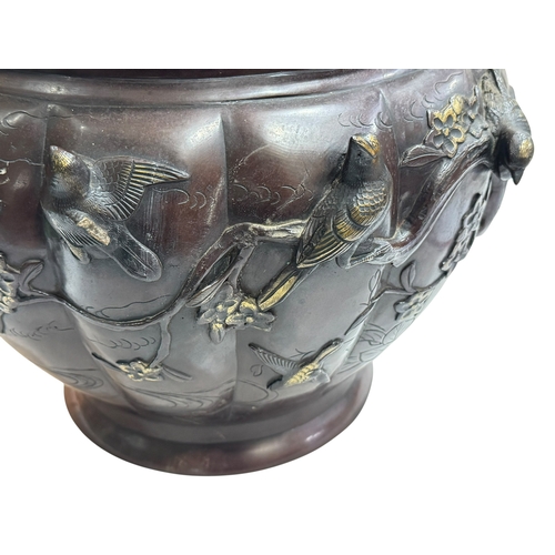 152 - Large Japanese bronze jardiniere decorated with raised bird and foliage, 28cm high by 40cm deep.