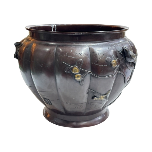 152 - Large Japanese bronze jardiniere decorated with raised bird and foliage, 28cm high by 40cm deep.