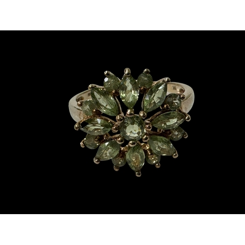 179 - Peridot flower cluster 9 carat gold ring, size N/O.