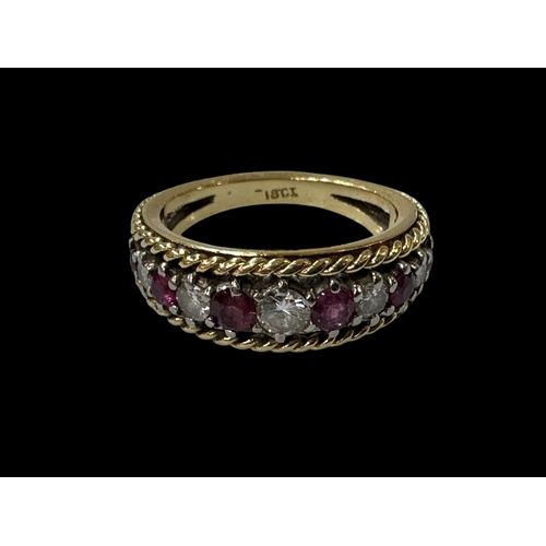 187 - Ruby and diamond eleven stone 18 carat gold ring, size N.