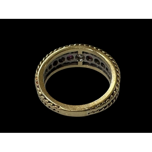 187 - Ruby and diamond eleven stone 18 carat gold ring, size N.