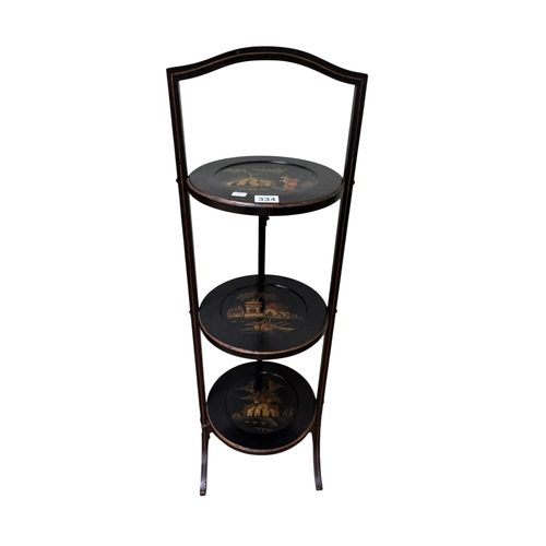 334 - Chinoiserie lacquered three tier folding cakestand, 86cm by 27cm.
