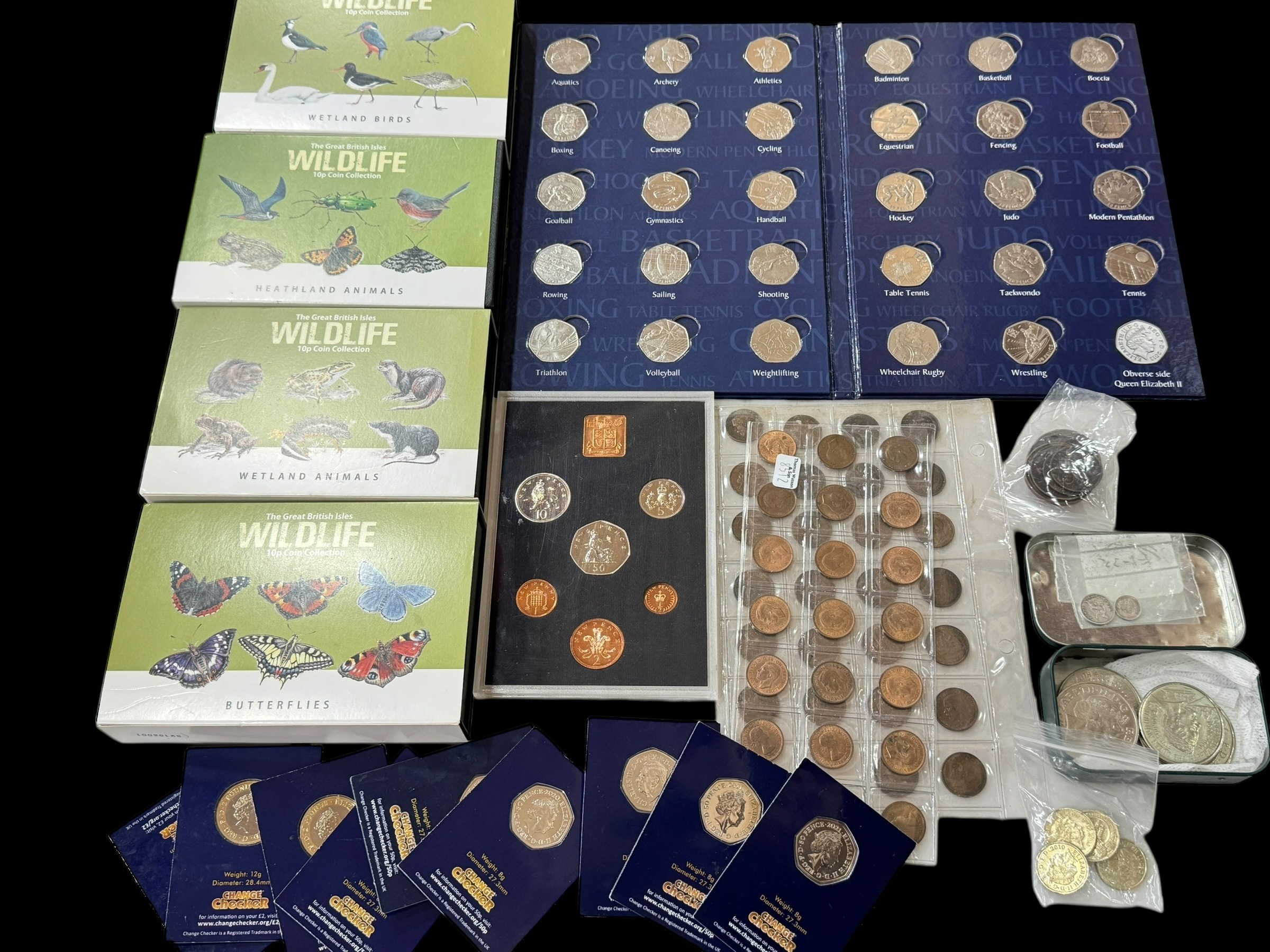 Collection of coins including British Wildlife and 50p Sports Album.