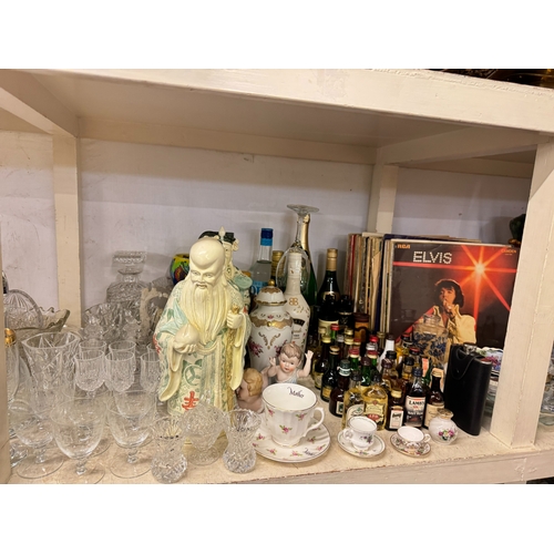106 - Full shelf of china, glass, spirits and spirit measures, LP records, dinnerware, etc.