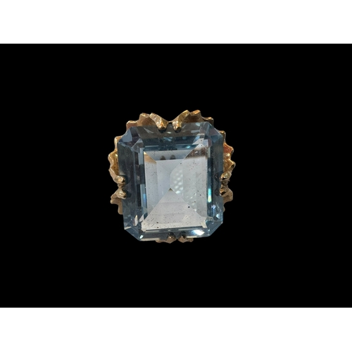 145 - Emerald cut aquamarine colour gem, ornate set 9 carat gold ring, size N.