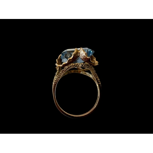 145 - Emerald cut aquamarine colour gem, ornate set 9 carat gold ring, size N.