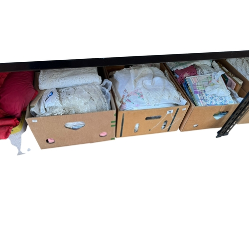 75 - Eleven boxes of assorted lace and linen eiderdowns, bed covers, etc.