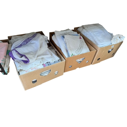 75 - Eleven boxes of assorted lace and linen eiderdowns, bed covers, etc.