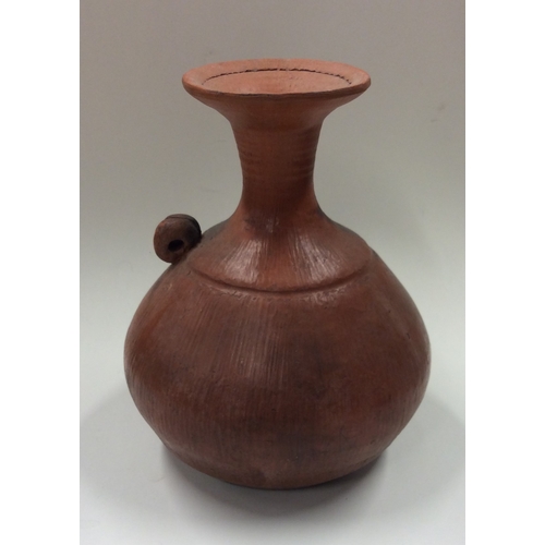 486 - ELSA BENATTAR (Danish: b. 1942): A small baluster shaped pit-fired earthenware pottery vase with sle... 