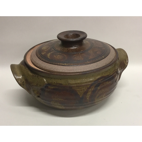 489 - MICK MORGAN (British b. c1950): A stoneware lidded soup tureen with chunky lug handles in muted oliv... 