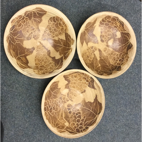 490 - A set of three stoneware pottery bowls with incised grape and vine pattern. Impressed mark 'S' to ba... 