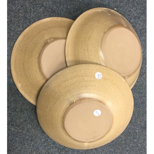 490 - A set of three stoneware pottery bowls with incised grape and vine pattern. Impressed mark 'S' to ba... 