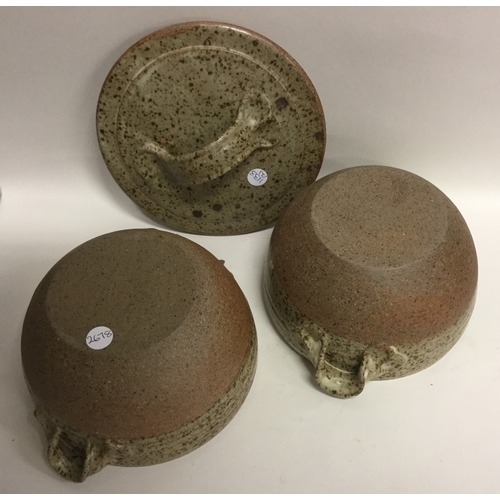 493 - A pair of lidded stoneware pottery soup bowls with lug handles of fluted speckled design. Apparently... 