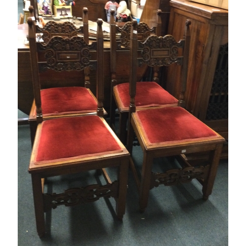 62 - A set of four carved oak dining chairs.