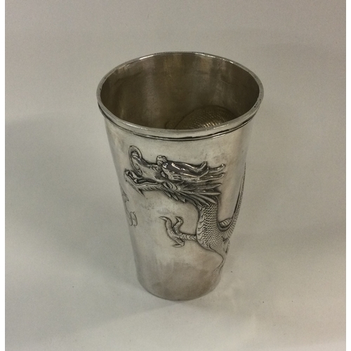 105 - An unusual Chinese silver tapering beaker with dragon decoration. Approx. 82 grams. Est. £150 - £200... 