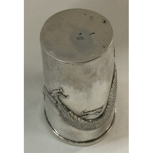 105 - An unusual Chinese silver tapering beaker with dragon decoration. Approx. 82 grams. Est. £150 - £200... 