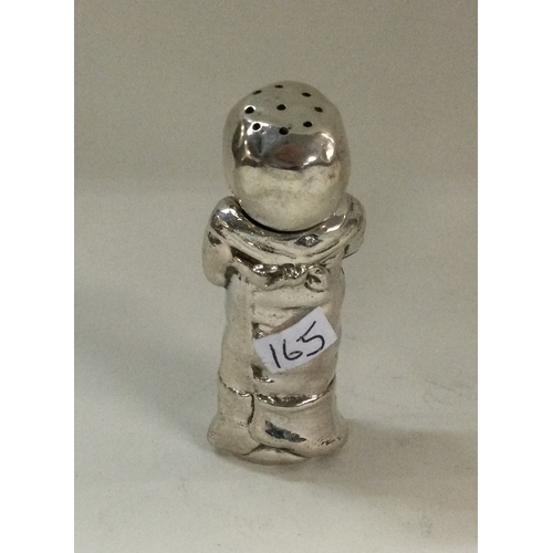 165 - An unusual novelty silver pepper in the form of a baby. Marked to base. Approx. 35 grams. Est. £70 -... 