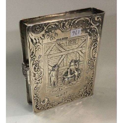 176 - A 19th Century Dutch silver box in the form of a book, heavily chased with musicians. London import ... 