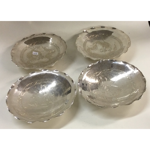 177 - A good set of four Chinese silver dishes on feet. Marked to base with dragon and bamboo design. Appr... 