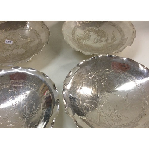 177 - A good set of four Chinese silver dishes on feet. Marked to base with dragon and bamboo design. Appr... 