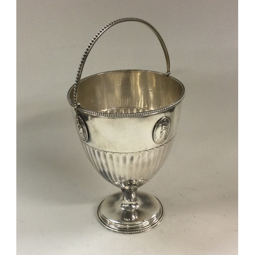 182 - A George III Neo-classical swing handled silver basket with oval plaques. London 1781. By Burrage Da... 