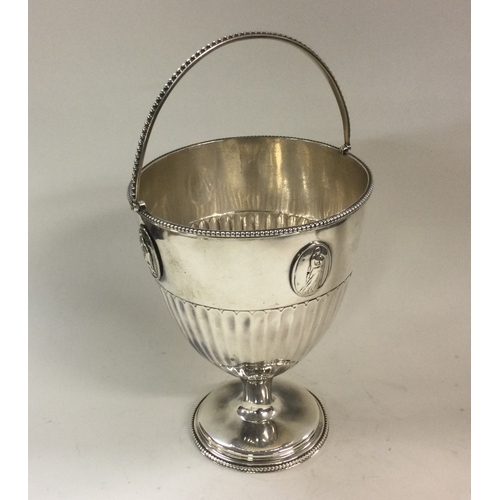 182 - A George III Neo-classical swing handled silver basket with oval plaques. London 1781. By Burrage Da... 