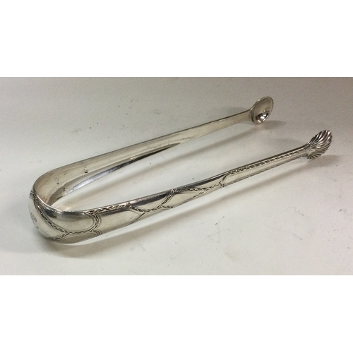 247 - DUBLIN: A fine pair of Irish 18th Century silver sugar tongs. By Benjamin Tate. Approx. 43 grams. Es... 