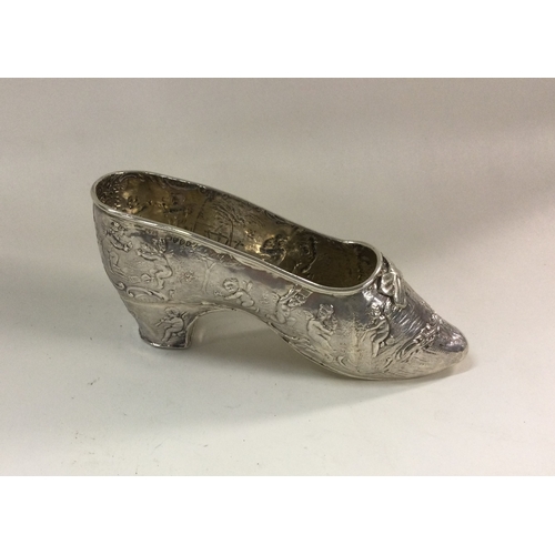 367 - A heavy chased silver miniature model of a shoe, bearing import marks. Marked to side and base. Appr... 